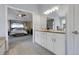 Elegant bathroom featuring double vanity sinks, granite countertops, and access to the main bedroom at 7472 S Utica St, Littleton, CO 80128