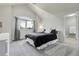 Bedroom features vaulted ceilings, a large window with curtains, and a connecting bathroom with a toilet and shower at 7472 S Utica St, Littleton, CO 80128