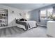 Cozy bedroom features a bookshelf, a view from the window, and plush carpet at 7472 S Utica St, Littleton, CO 80128