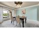 Charming dining room with a large window, modern light fixture, and an elegant table set at 7472 S Utica St, Littleton, CO 80128