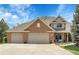 Beautiful home with a three-car garage and a charming front porch, perfect for relaxing outdoors at 7472 S Utica St, Littleton, CO 80128