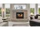 Inviting fireplace with a brick surround, a cozy seating area, and natural light from nearby windows at 7472 S Utica St, Littleton, CO 80128