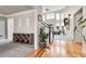 Bright foyer with hardwood floors, an elegant staircase, and an open view into the living area at 7472 S Utica St, Littleton, CO 80128