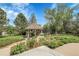 Charming gazebo nestled in a beautifully landscaped backyard with mature trees and vibrant greenery at 7472 S Utica St, Littleton, CO 80128