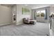 Open hallway features a cozy sitting area and views of the trees through the large window at 7472 S Utica St, Littleton, CO 80128
