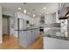 Spacious kitchen with stainless steel appliances, granite countertops, and stylish island at 7472 S Utica St, Littleton, CO 80128