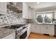 Modern kitchen showcasing stainless steel appliances, granite countertops, and a bright window at 7472 S Utica St, Littleton, CO 80128