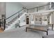 Open-concept living room with a loft area, fireplace, neutral decor, and a staircase at 7472 S Utica St, Littleton, CO 80128