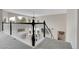 An open loft overlooks the living area with abundant light from large windows and a black and white spindle staircase at 7472 S Utica St, Littleton, CO 80128