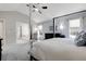 Serene main bedroom displaying a four-poster bed and a comfortable sitting area at 7472 S Utica St, Littleton, CO 80128