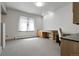 Well-lit office featuring built-in desk, carpeted floors, and large window providing natural light at 7472 S Utica St, Littleton, CO 80128