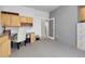 Bright office space with built-in wooden cabinets and desk, offering ample storage and workspace at 7472 S Utica St, Littleton, CO 80128
