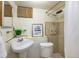 Cozy bathroom with pedestal sink and tiled shower, providing a functional space at 11940 W Independence Ave, Lakewood, CO 80401
