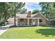 Charming brick home with a lush front lawn and a welcoming porch, perfect for relaxing outdoors at 11940 W Independence Ave, Lakewood, CO 80401