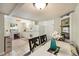 Bright kitchen featuring white cabinetry, tile flooring, and adjacent dining area for easy meals at 11940 W Independence Ave, Lakewood, CO 80401