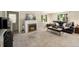 Spacious living room featuring a cozy fireplace, plush seating, and ample natural light at 11940 W Independence Ave, Lakewood, CO 80401