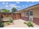 This cozy backyard features a private patio, a wooden fence, and charming garden beds for a relaxing outdoor space at 4233 Shoshone St, Denver, CO 80211
