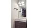 Contemporary bathroom with a sleek vanity, modern lighting, and a large mirror at 4233 Shoshone St, Denver, CO 80211