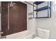Modern bathroom with subway tile, shower, and sleek shelving for storage at 4233 Shoshone St, Denver, CO 80211