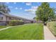Well-maintained front yard with lush lawn and mature trees, creating inviting curb appeal at 4233 Shoshone St, Denver, CO 80211