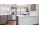 Renovated kitchen boasts stainless steel appliances, white countertops, and modern cabinetry at 4233 Shoshone St, Denver, CO 80211