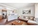 Bright, open living space with wood floors, neutral decor, and stainless steel appliances at 4233 Shoshone St, Denver, CO 80211