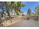 Back deck features railings and wooden beams overlooking the neighborhood at 8159 Lodgepole Trl, Lone Tree, CO 80124