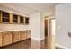 Home bar area with custom cabinets and a sink, perfect for entertaining guests with hardwood floors at 8159 Lodgepole Trl, Lone Tree, CO 80124
