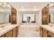 Bathroom featuring dual vanities, a large soaking tub, and ample counter space at 8159 Lodgepole Trl, Lone Tree, CO 80124