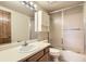 Bright bathroom features a vanity with a white sink and a tub shower combo with sliding glass doors at 8159 Lodgepole Trl, Lone Tree, CO 80124