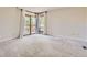 The bedroom features natural light from a window leading to a wooden deck overlooking trees at 8159 Lodgepole Trl, Lone Tree, CO 80124