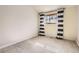 Bedroom featuring a window with striped curtains and neutral carpet at 8159 Lodgepole Trl, Lone Tree, CO 80124