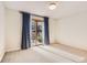 Bedroom with natural light, neutral carpet, and sliding glass doors to the outside at 8159 Lodgepole Trl, Lone Tree, CO 80124