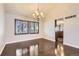 Bright dining room with hardwood floors, modern chandelier and natural light coming through large windows at 8159 Lodgepole Trl, Lone Tree, CO 80124