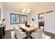 Dining room featuring a chandelier, wood floors, and large windows with blinds at 8159 Lodgepole Trl, Lone Tree, CO 80124