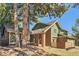 Charming green home with brick accents and mature trees in a peaceful setting at 8159 Lodgepole Trl, Lone Tree, CO 80124