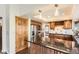 Stylish kitchen with stainless steel appliances, granite countertops, an island, and wood cabinetry at 8159 Lodgepole Trl, Lone Tree, CO 80124