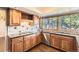 Well-lit kitchen featuring wooden cabinets, granite countertops, decorative backsplash, and stainless steel appliances at 8159 Lodgepole Trl, Lone Tree, CO 80124