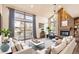 Spacious living room with a fireplace, large windows, and comfortable seating at 8159 Lodgepole Trl, Lone Tree, CO 80124