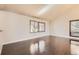Bright living room featuring high ceilings, hardwood floors, and large windows with blinds offering natural light at 8159 Lodgepole Trl, Lone Tree, CO 80124