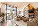 Inviting living room features a cozy fireplace, deck access, and large windows providing ample natural light at 8159 Lodgepole Trl, Lone Tree, CO 80124
