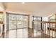 View of indoor living space with hardwood floors, a large sliding glass door to a patio, and wood railing at 8159 Lodgepole Trl, Lone Tree, CO 80124