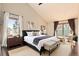 Light-filled main bedroom features a large bed, a private balcony and an abundance of natural light at 8159 Lodgepole Trl, Lone Tree, CO 80124