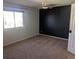 Bedroom featuring a window, black accent wall, ceiling fan and door at 431 S Kalispell Way # 308, Aurora, CO 80017