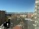 Scenic city view showcasing building rooftops, snow-capped mountains, and a clear blue sky at 789 N Clarkson St # 906, Denver, CO 80218