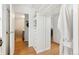 A closet with storage shelves is displayed with light hardwood floors and access to the bathroom at 789 N Clarkson St # 906, Denver, CO 80218