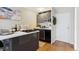 Stylish kitchen with sleek cabinetry, modern appliances, an island with a cooktop, and hardwood flooring at 789 N Clarkson St # 906, Denver, CO 80218
