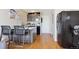 Modern kitchen with stainless steel appliances, an island with seating, and hardwood floors at 789 N Clarkson St # 906, Denver, CO 80218