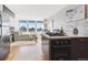 Open concept living area featuring hardwood floors, large windows with city views, and a modern kitchen at 789 N Clarkson St # 906, Denver, CO 80218