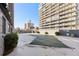 View of the in-ground, covered pool and surrounding condo buildings on a bright, sunny day at 789 N Clarkson St # 906, Denver, CO 80218